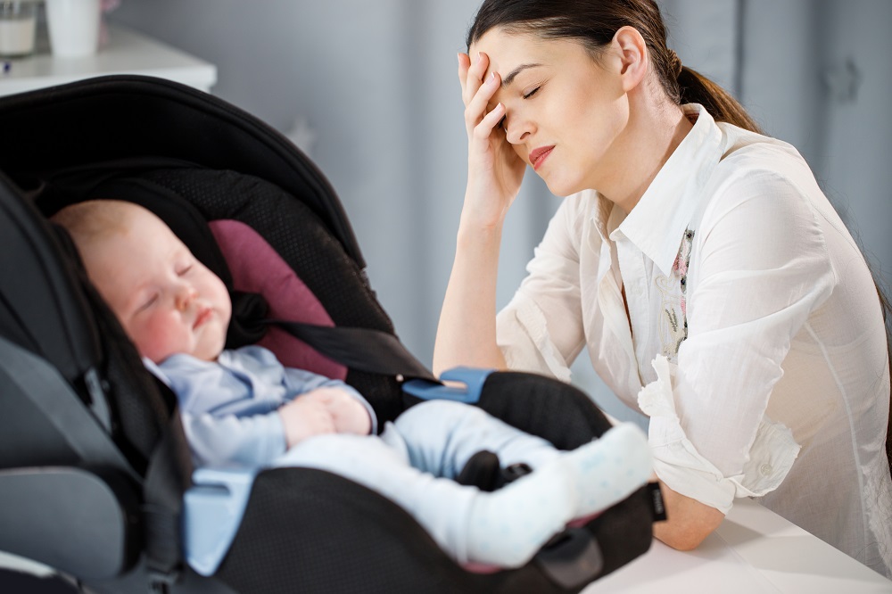 Mom Struggling to cary her baby's carrier