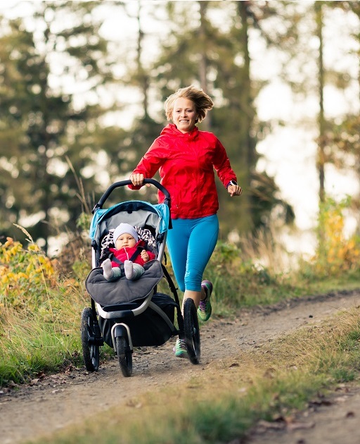 Woman rinning with baby stroller