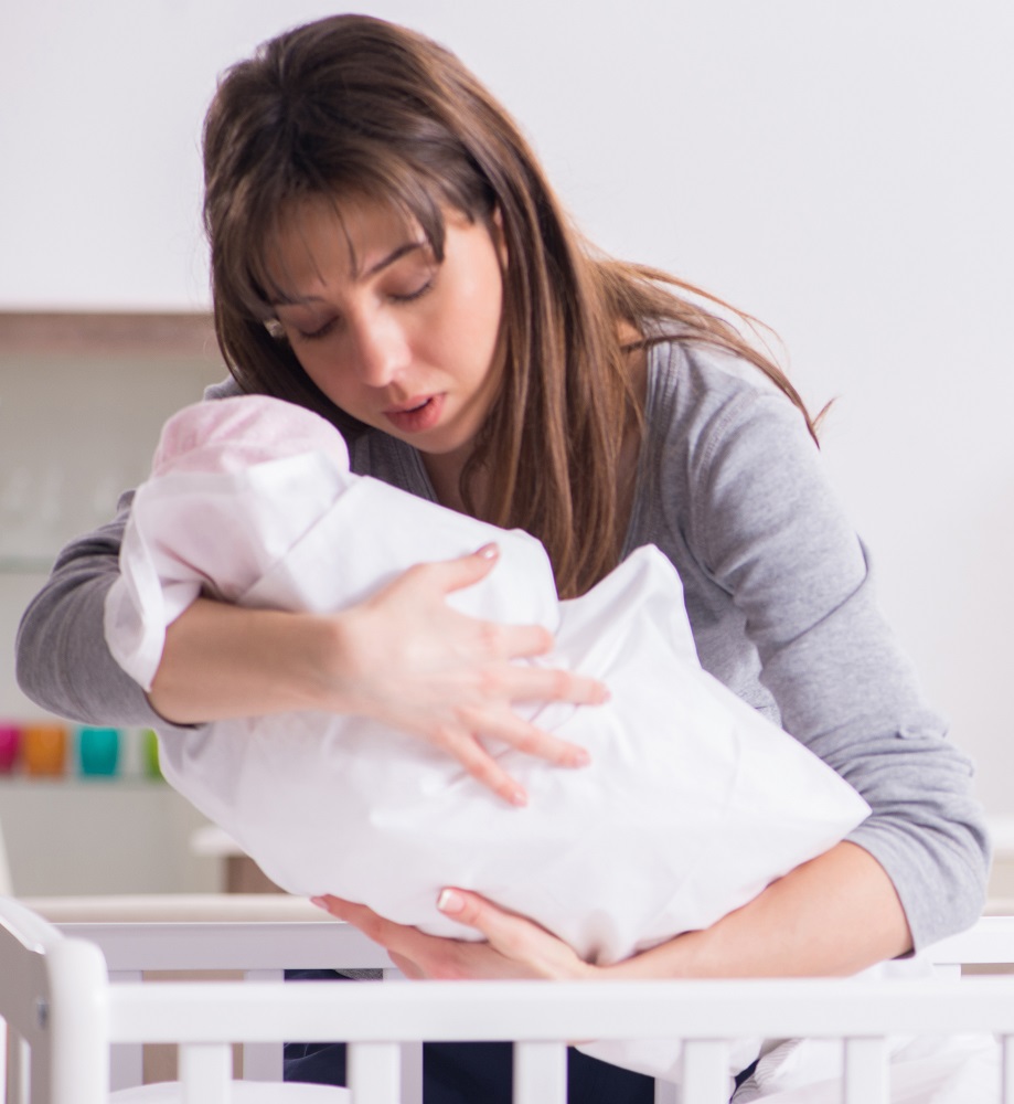 Mom with baby at crib